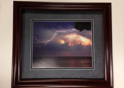 framed lightning across water photo